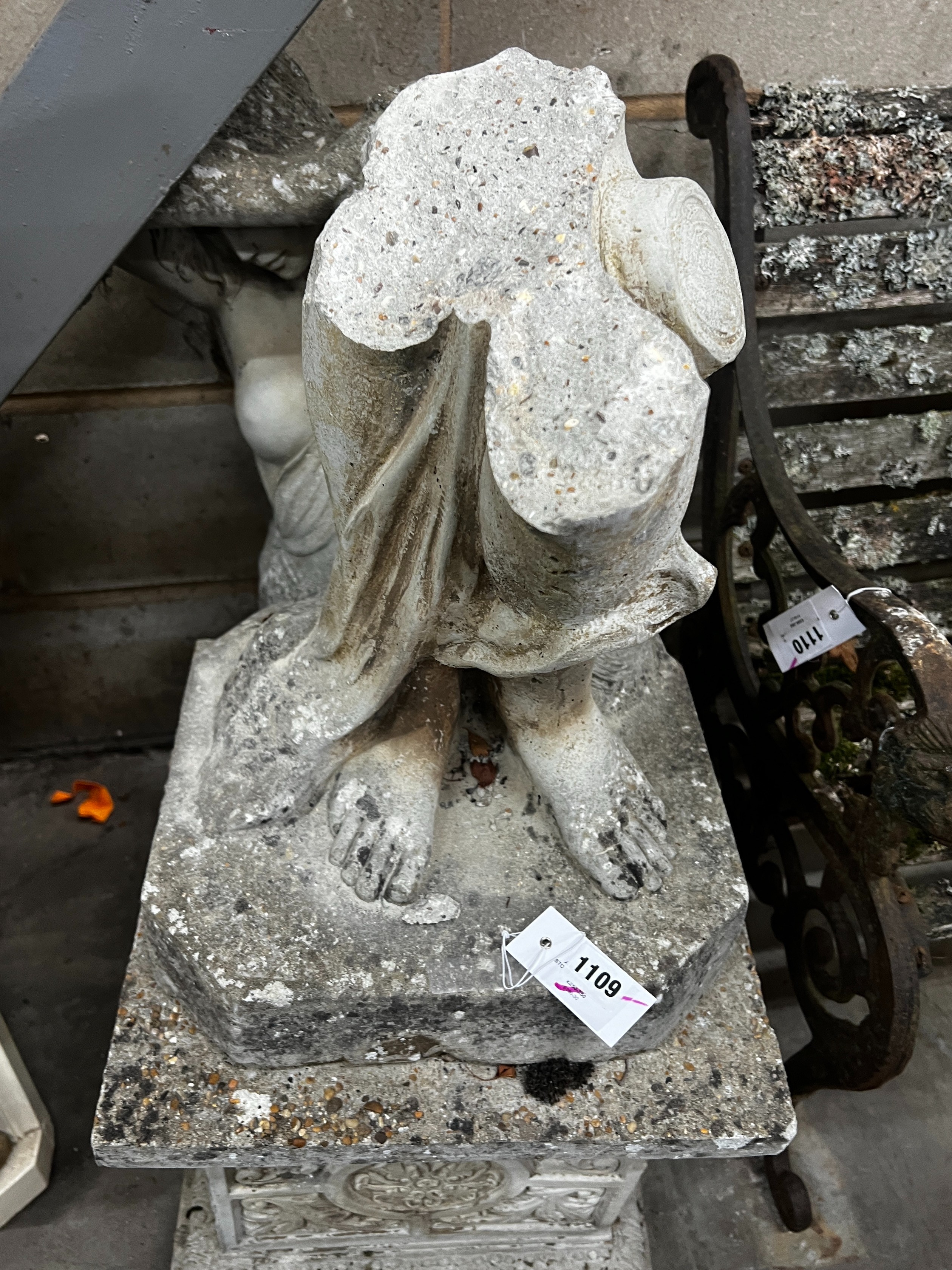 A reconstituted stone garden figure of a lady, wearing a diaphanous gown, on a square plinth, height 162cm (in need of restoration)